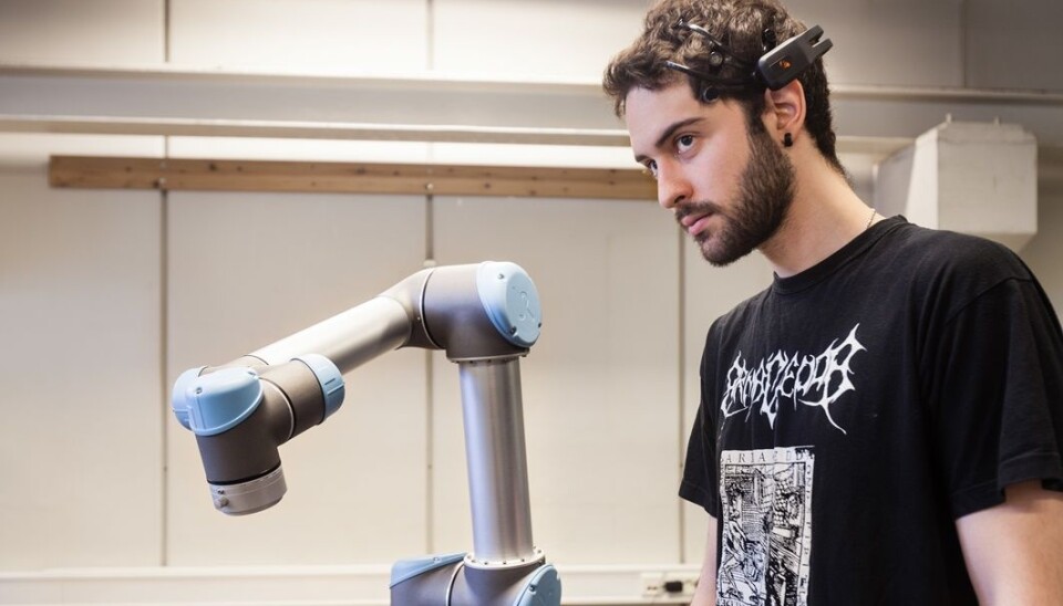 Student Angel Garcia use his eyes, eyebrows and other parts of his face to make the robot move. (Photo: Thor Nielsen)