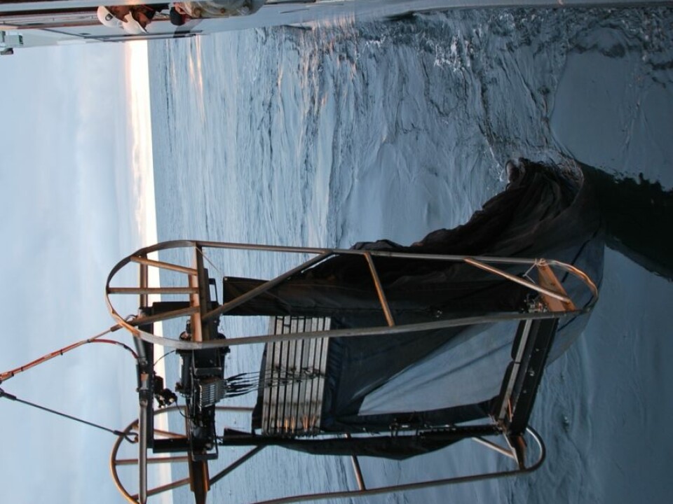 Scientists pay close attention while this MOCNESS plankton net is lowered into the sea. The net takes nine different plankton samples – one all the way down the column of water from the surface to 1,000 metres, and eight from various depths on the way up. (Photo: Hanne Østli Jakobsen)