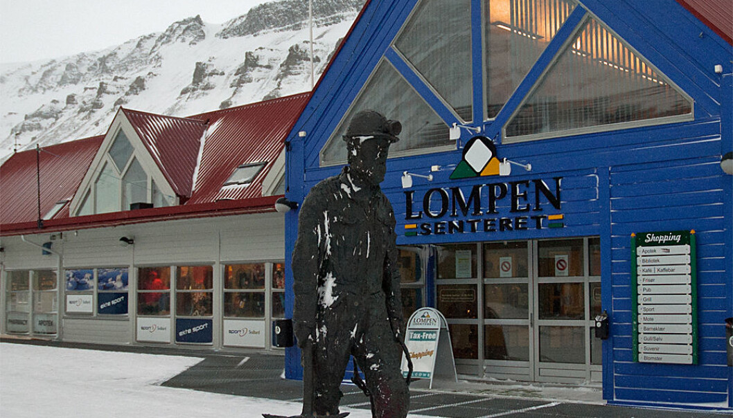 The town of Longyearbyen has a modern shopping centre and clothing and outdoor stores along its main pedestrian street. But the statue of the coal miner is a reminder of who - or what - really dominates the economy. (Photo: Georg Mathisen) The town of Longyearbyen has a modern shopping centre and clothing and outdoor stores along its main pedestrian street. But the statue of the coal miner is a reminder of who - or what - really dominates the economy. (Photo: Georg Mathisen)