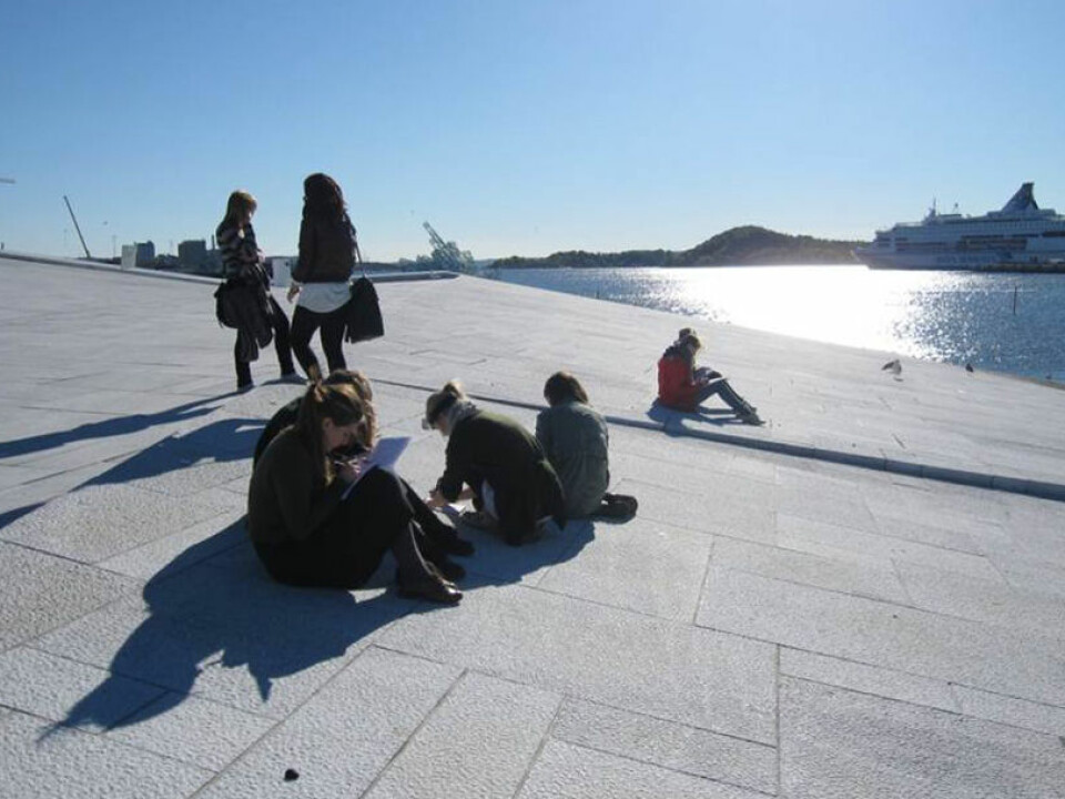 High school students working on a geoscience assignment on the sloping facade of Oslo’s Opera and Ballet, which is clad in white granite and Italian marble.  (Photo: Kari Beate Remmen)