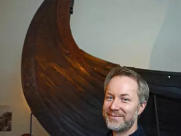 Runologist Jonas Nordby is a code-breaker. The Oseberg Ship behind him also contained one of many riddles from the Viking Era. (Photo: Ida Kvittingen)