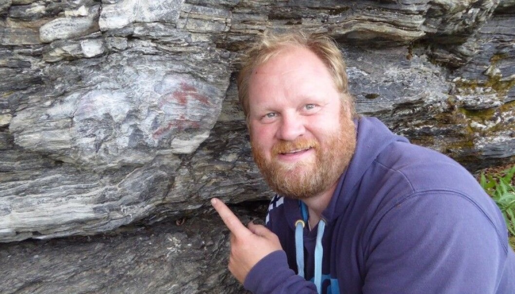 Researcher Jan Magne Gjerde at the Department of Archaeology, History, Religious Studies and Theology at the Arctic University of Norway found two new sites with ancient petroglyphs or rock art at the Alta Fjord. He is seen here with a male figure, probably from the Younger Stone Age (4000 BCE to 1800 BCE), probably painted with a mixture of ochre and animal fat. (Photo: UiT, The Arctic University of Norway) Researcher Jan Magne Gjerde at the Department of Archaeology, History, Religious Studies and Theology at the Arctic University of Norway found two new sites with ancient petroglyphs or rock art at the Alta Fjord. He is seen here with a male figure, probably from the Younger Stone Age (4000 BCE to 1800 BCE), probably painted with a mixture of ochre and animal fat. (Photo: UiT, The Arctic University of Norway)