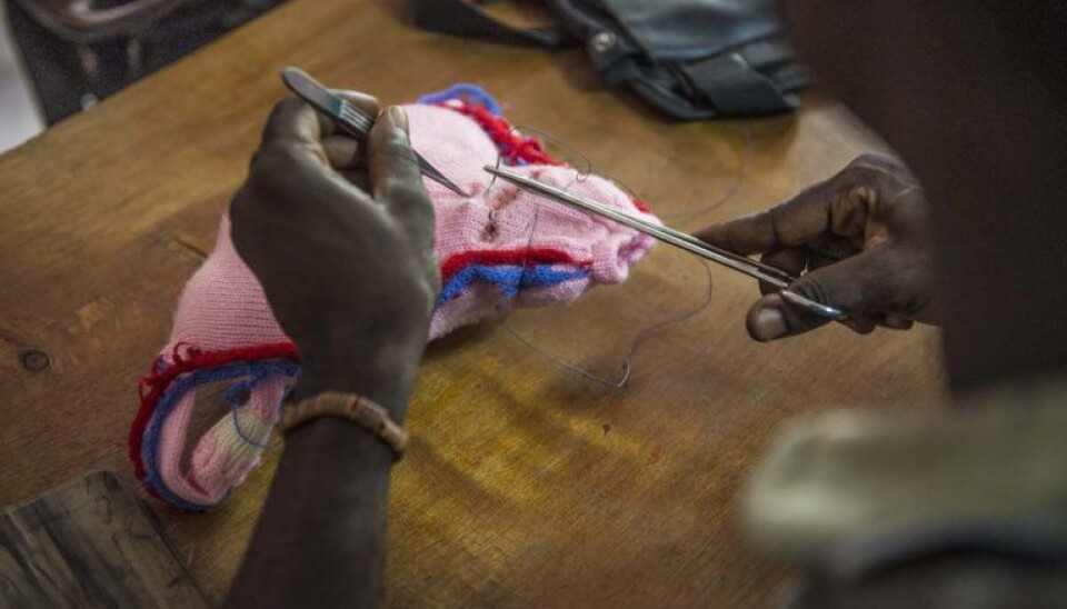 Practicing on a knitted model of a uterus — an innovative, if unusual, way to develop the fine motor skills needed to do sutures. (Photo: Magnus Endal, CapaCare)