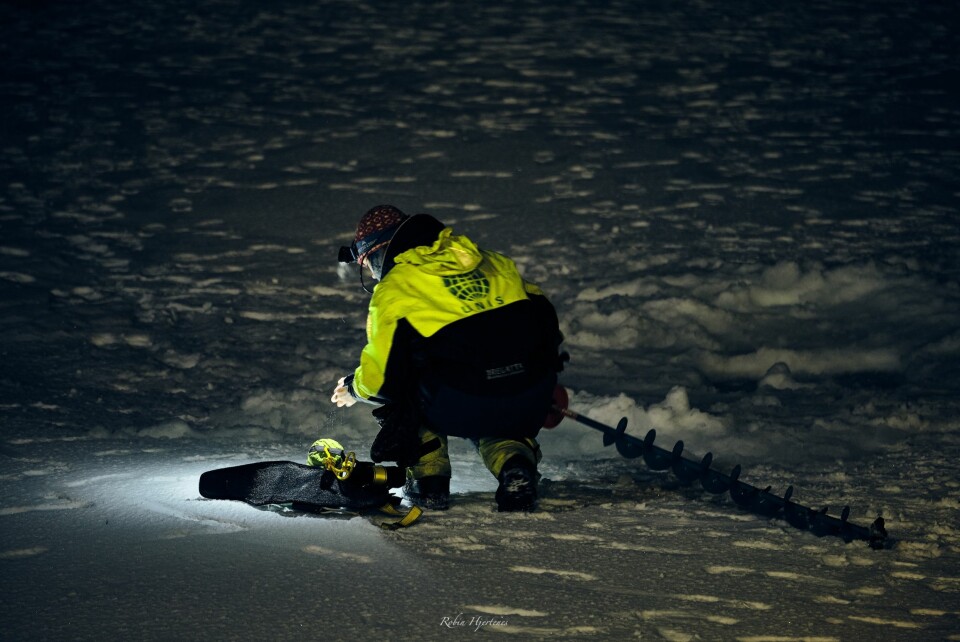 Drilling sea ice cores in complete darkness.