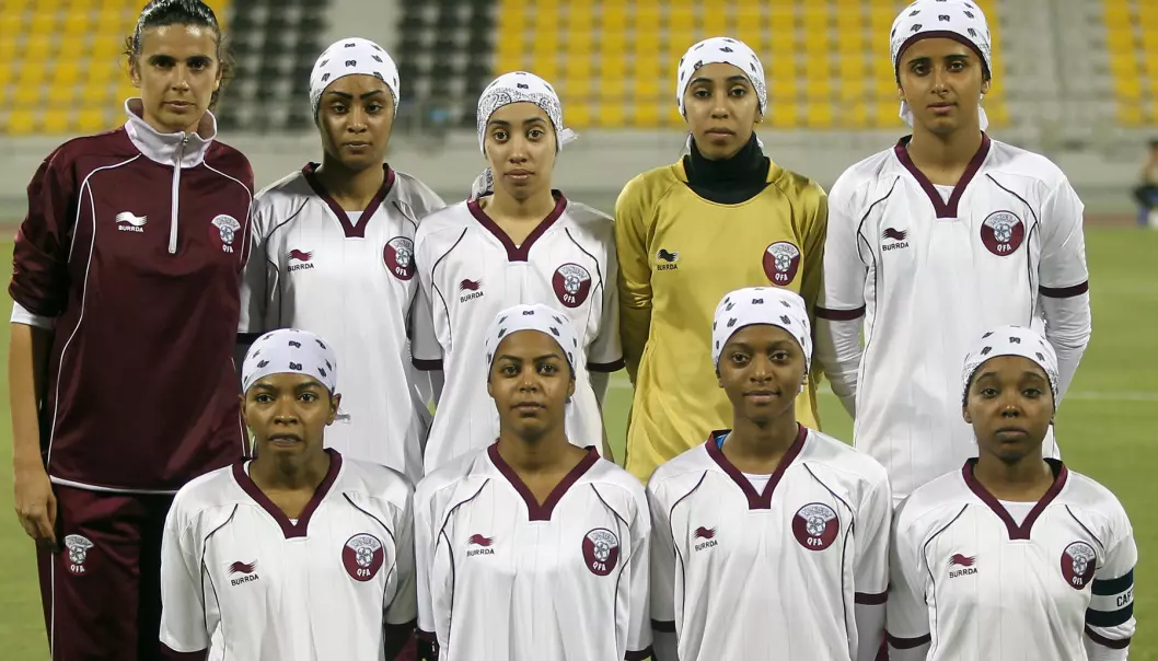 Members of the Qatar women's football team line up prior to a friendly game against Kuwait in May 2012.