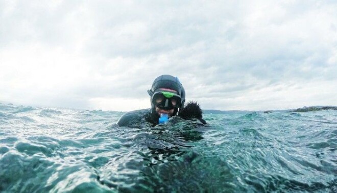 Diver with sea urchin catch. Diver with sea urchin catch.
