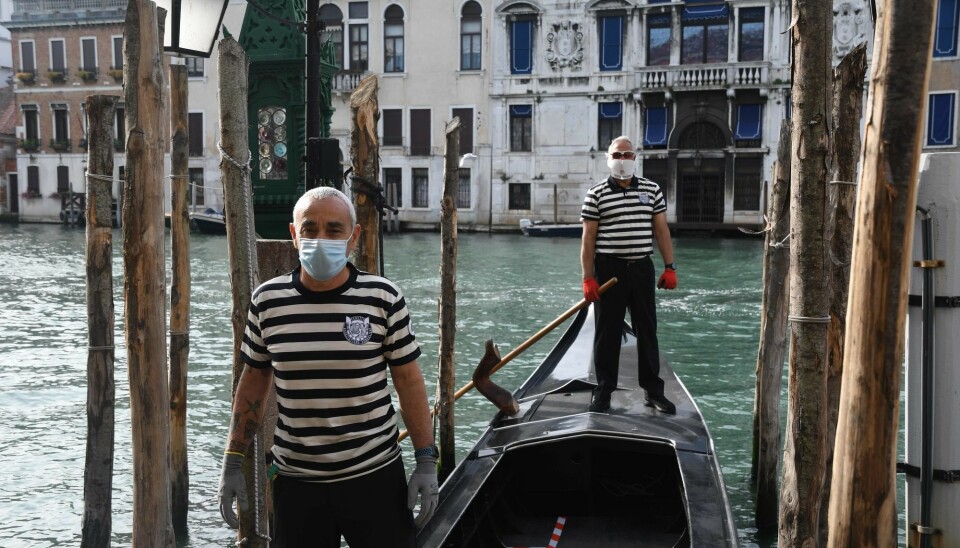 The use of face masks was made mandatory on public transport and in stores in Italy as the country gradually loosend lockdown measures. Gondoliers wearing a face mask stand on a gondola on a Venice canal as they resumed their service on May 18, 2020.