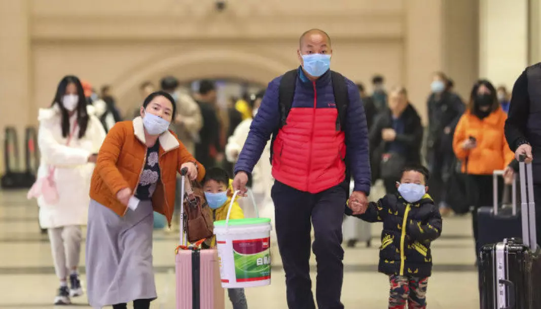 A chinese family with face masks at the train station Hankou in Wuhan 21 January 2020.
