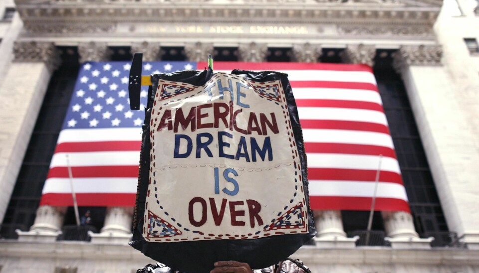 A protester outside the New York Stock Exchange expresses his loss of faith in the American dream.