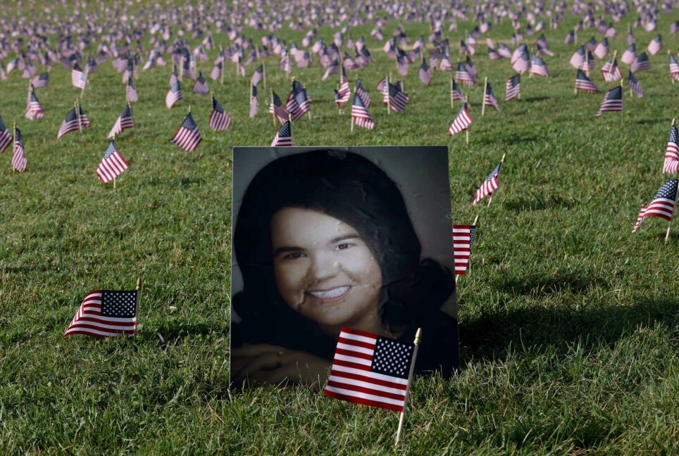 A photograph of 75 year old Constance Duncan, who died from COVID on her birthday, is shown at a COVID Memorial Project installation of 20,000 American flags on the National Mall.