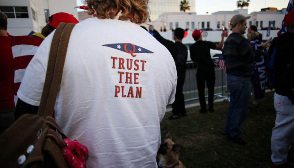 A Trump supporter wearing a QAnon t-shirt during a demonstration in California in November. Supporters of QAnon believe there is a secret network of powerful people in the United States, including the Clintons and Obamas, who rule the world. The organization believes that Donald Trump is their salvation.