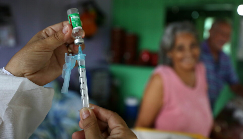 A municipal health worker prepares a dose of the AstraZeneca/Oxford vaccine at the the Sustainable Development Reserve of Tupe in the Negro river banks in Manaus, Brazil, February 9, 2021.