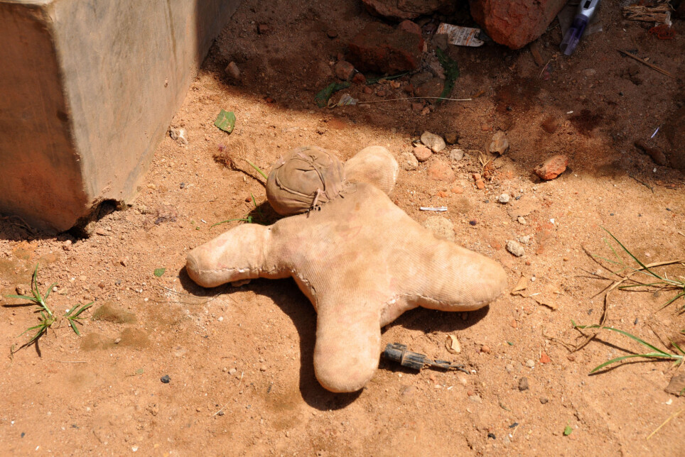 A handmade doll on a dirt road in an urban slum in Uganda.