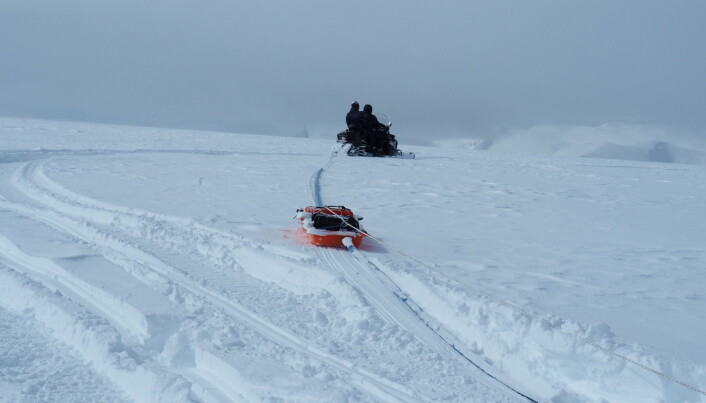 A snowmobile towing georadar equipment. A snowmobile towing georadar equipment.