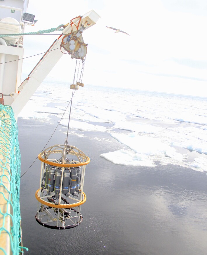 CTD lowered into the waters next to the sea ice. CTD lowered into the waters next to the sea ice.