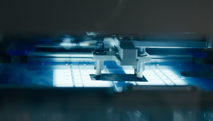 The picture shows a stacking machine, which is used to stack layers of anodes intercalated with cathodes. A separating layer is used to isolate the anode from the cathode. Tape is used to hold the stacked layers together. The picture shows a stacking machine, which is used to stack layers of anodes intercalated with cathodes. A separating layer is used to isolate the anode from the cathode. Tape is used to hold the stacked layers together.