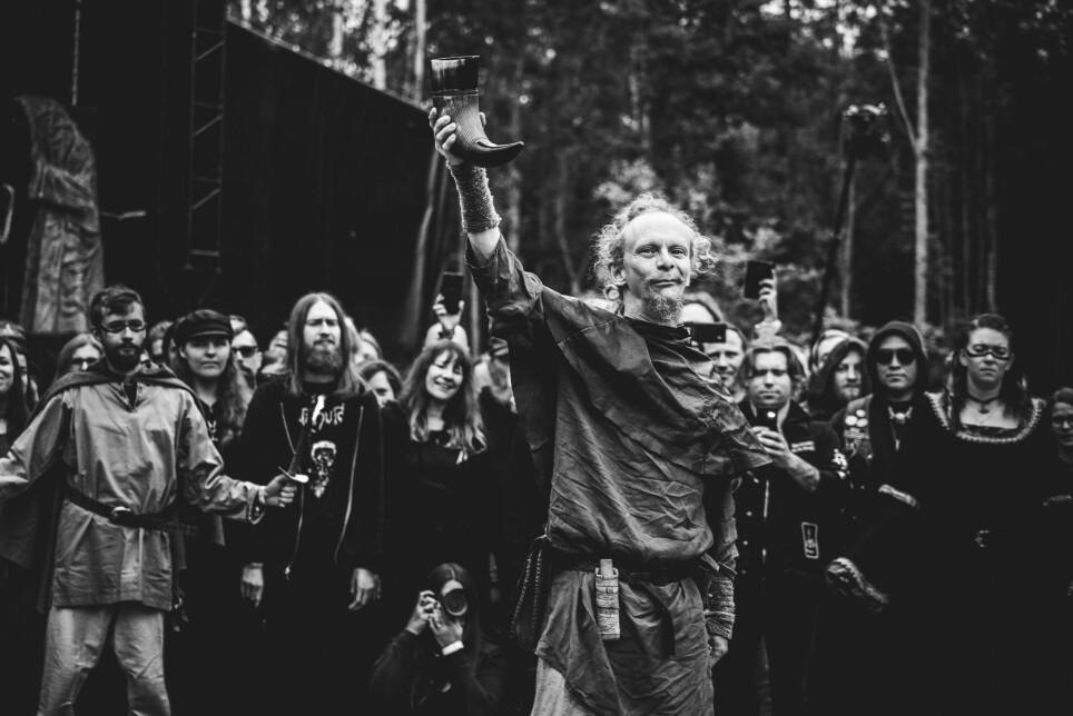 Gustav Holberg from the folk music group Folket Bortafor Nordavinden (the People Beyond the Northwind) holds his drinking horn up high during the opening ceremony of the extreme metal and Viking Age festival Midgardsblot. The festival attracts thousands of people from all over the world annually since 2014.