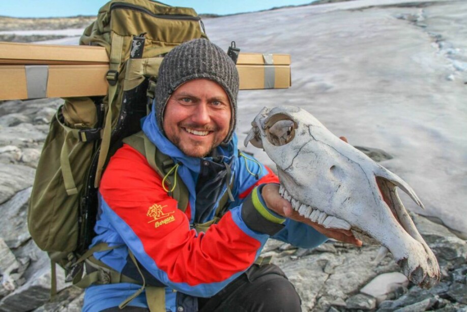 Elling Utvik Wammer holding the skull of an unlucky packhorse that did not make it across the Lendbreen ice.