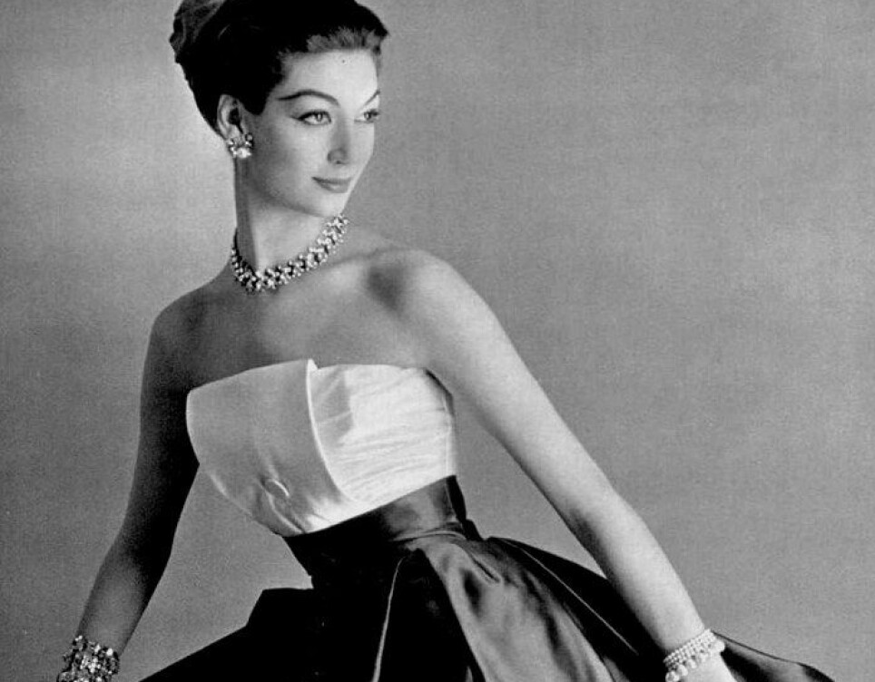 Parisian fashion has always been characterized by exclusivity and luxury. Here, a model poses in an elegant dress of Maggy Rouff's fashion house in Paris, 1958.