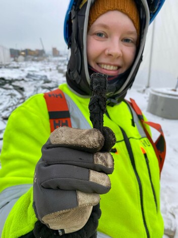 A cold but happy archaeologist holding what NIKU claims is "one of the decade's finest archaeological artefacts from Oslo" A cold but happy archaeologist holding what NIKU claims is "one of the decade's finest archaeological artefacts from Oslo"