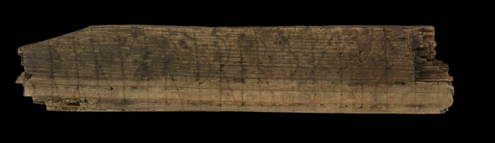 The rune stick has inscriptions in both Latin and Norse, on three sides.
