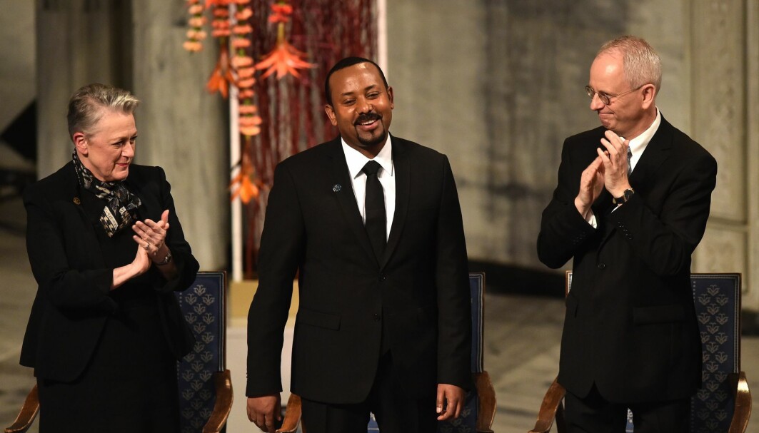 Chair of the Norwegian Nobel Peace Prize comitee Berit Reiss-Andersen and Vice Chair of the Norwegian Nobel Peace Prize comitee Henrik Syse applaud Ethiopia's Prime Minister and Nobel Peace Prize Laureate Abiy Ahmed Ali during the Nobel Peace Prize ceremony at the city hall in Oslo, Norway on December 10, 2019. Chair of the Norwegian Nobel Peace Prize comitee Berit Reiss-Andersen and Vice Chair of the Norwegian Nobel Peace Prize comitee Henrik Syse applaud Ethiopia's Prime Minister and Nobel Peace Prize Laureate Abiy Ahmed Ali during the Nobel Peace Prize ceremony at the city hall in Oslo, Norway on December 10, 2019.
