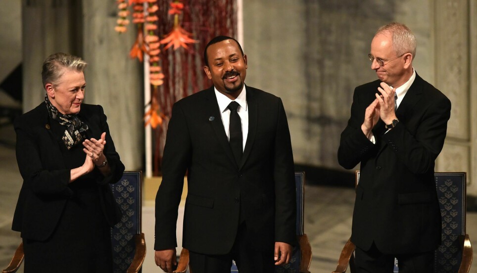 Chair of the Norwegian Nobel Peace Prize comitee Berit Reiss-Andersen and Vice Chair of the Norwegian Nobel Peace Prize comitee Henrik Syse applaud Ethiopia's Prime Minister and Nobel Peace Prize Laureate Abiy Ahmed Ali during the Nobel Peace Prize ceremony at the city hall in Oslo, Norway on December 10, 2019.