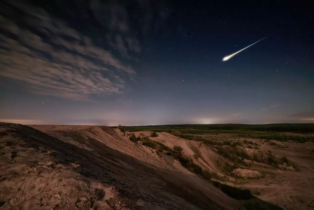 A meteor streaks across the sky.