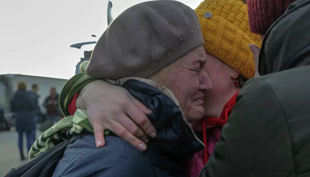 Ukrainian refugees cry as they reunite at the Medyka border crossing, Poland.