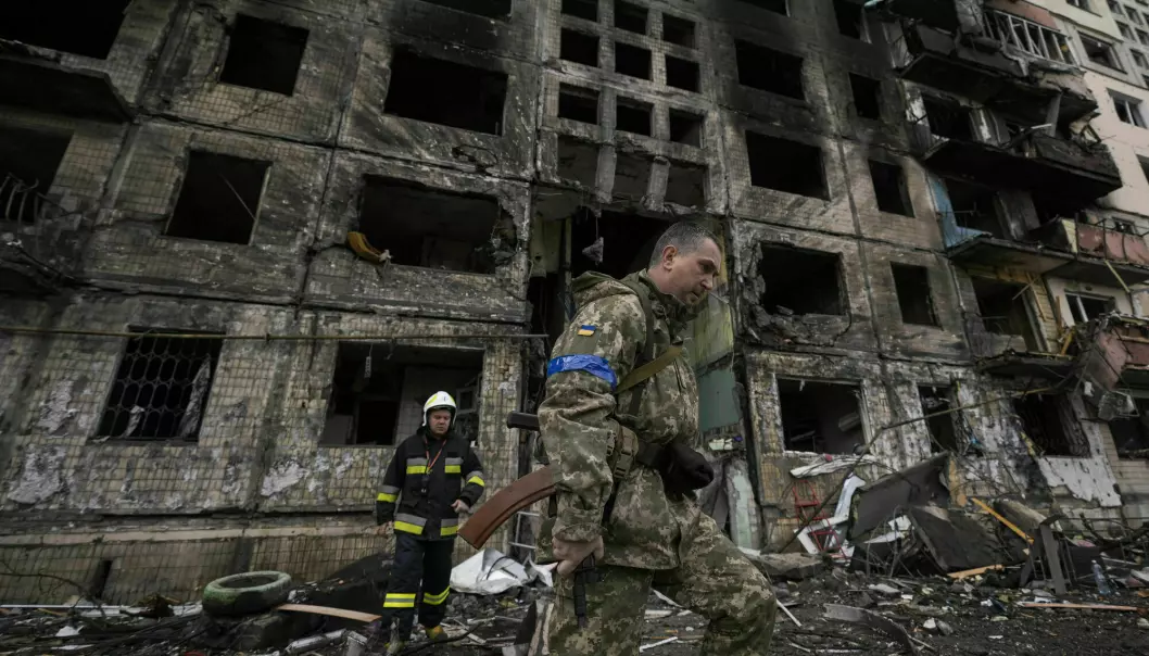 Soldiers and firefighters search a destroyed building after a bomb attack in Kyiv on Monday 14 March.