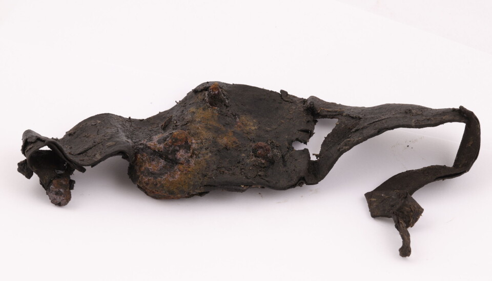 A crampon from medieval Oslo, complete with straps.