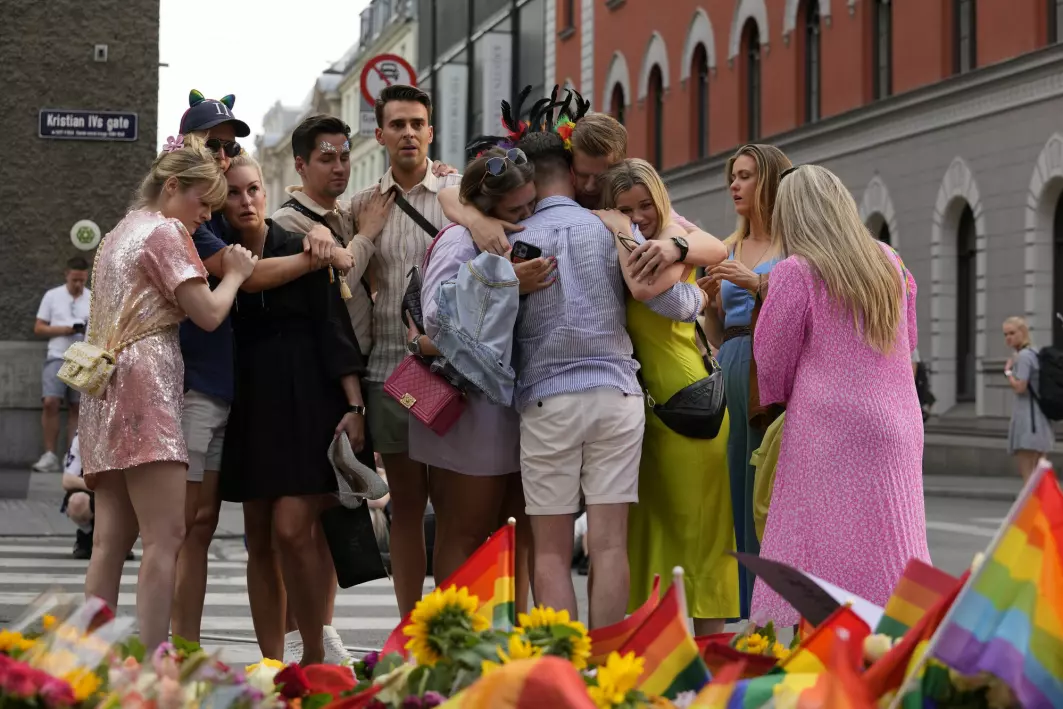 People comforting each other at the scene of the mass shooting in Oslo, Norway, Saturday, June 25. A gunman opened fire near an LGBT bar, killing two and injuring more than 20. Subsequent pride parades and memorials were cancelled upon recommendation from the police.