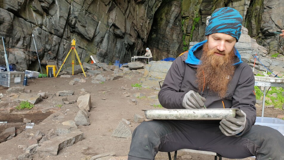 Erlend Kirkeng Jørgensen sorts through shards of pottery that have been collected from the excavation site.
