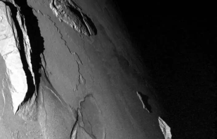 This picture shows mountains sticking straight up from Io's surface. The images were taken by the Galileo probe. These are not the moon’s highest mountains, but they are several kilometres high.