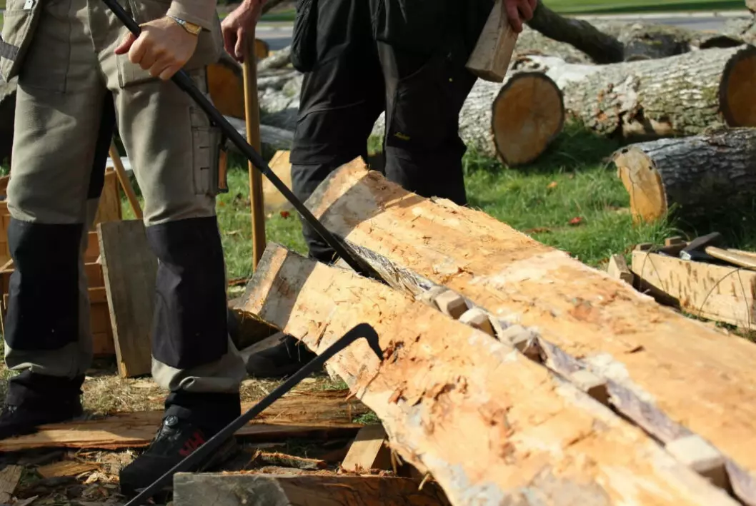 Wooden wedges help split the log.
