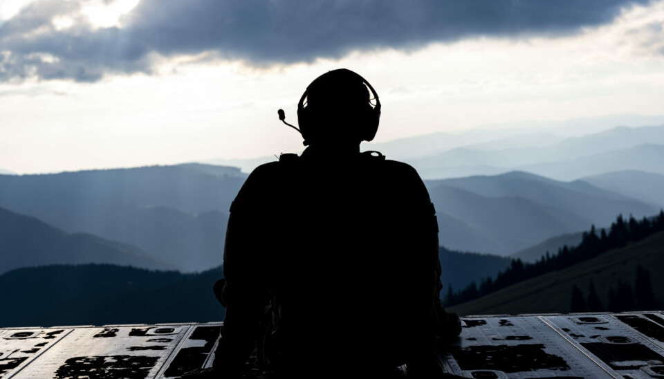 An American soldier looks out over Ukraine from the cargo hold of a Lockheed MC-130.