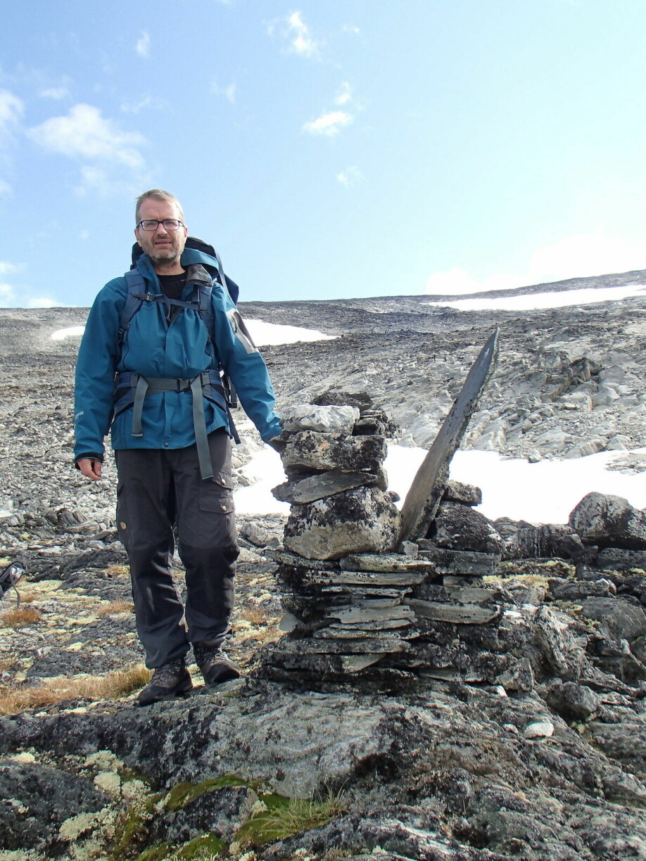 Archaeologist Lars Pilø photographed at Lendbreen. The moutain pass here was used for over 1200 years, and more than 800 items have been found by glacial archaeologists over the years.