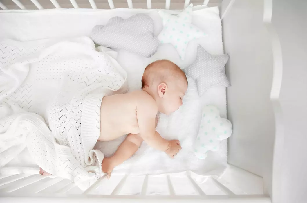 Should a baby co-sleep with its parents or sleep in its own bed? The debate continues.