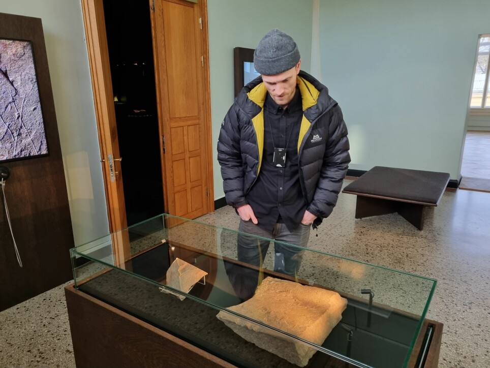 Project manager Steinar Solheim examines the Svingerud stone where it is now on display.