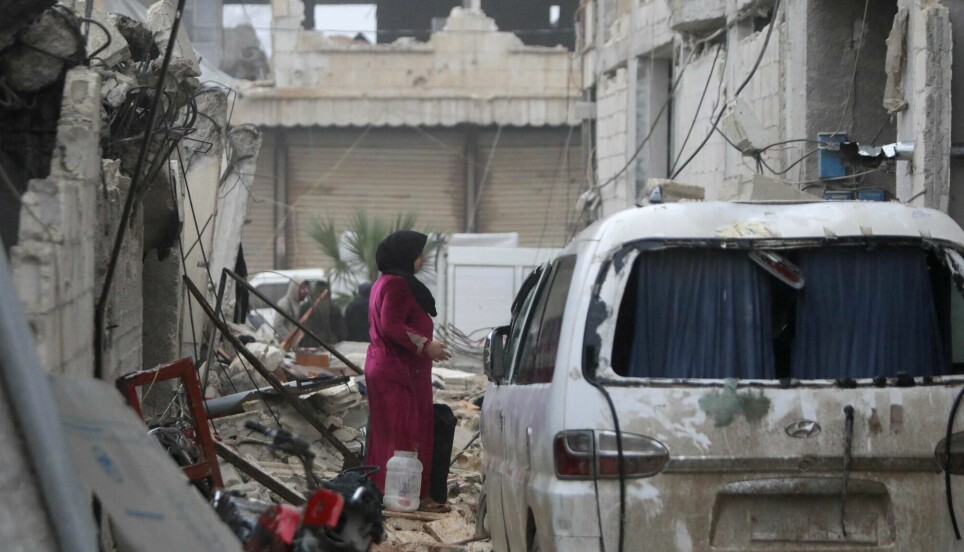 A woman walks through the rubble following an earthquake in the town of Jandairis, in the countryside of Syria's northwestern city of Afrin in the rebel-held part of Aleppo province, on February 6, 2023. Thousands have been reportedly killed in north Syria after a 7.8-magnitude earthquake that originated in Turkey and was felt across neighbouring countries.