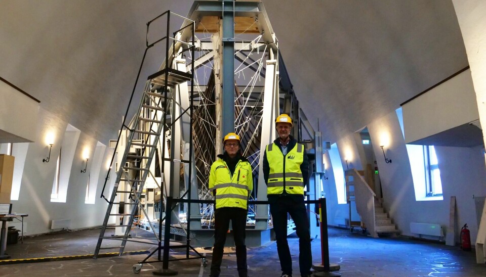 Director of the Museum, Håkon Glørstad and Project manager for the new Museum of the Viking Age Göran Joryd, in front of one of the Viking ships being encased in a steel rig to secure it while its new home is being built.