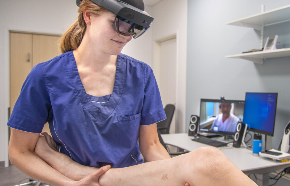 Physiotherapist Anna Osen Byberg (wearing a HoloLens augmented reality headset) seen here working with orthopaedist Ivar Hanssen at Helgeland Hospital. Hanssen can both observe the patient and instruct the physiotherapist in real time.