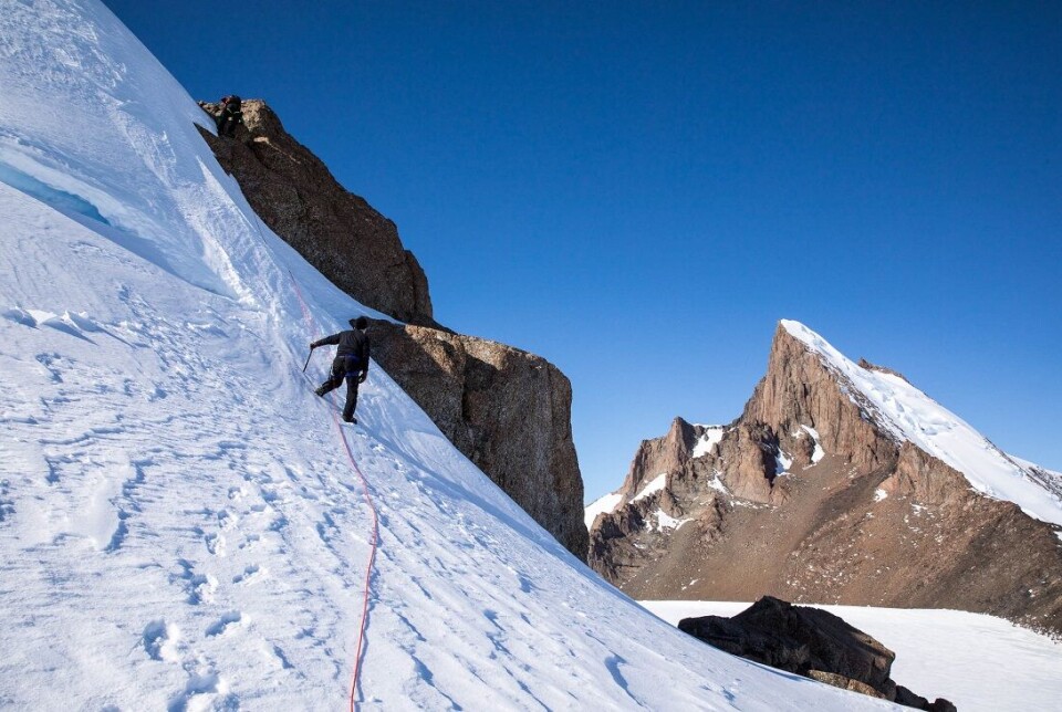 Researcher Nat Lifton (closest) and mountain guide Carl Lundberg (higher up) climb a small nunatak to look for suitable rock samples.