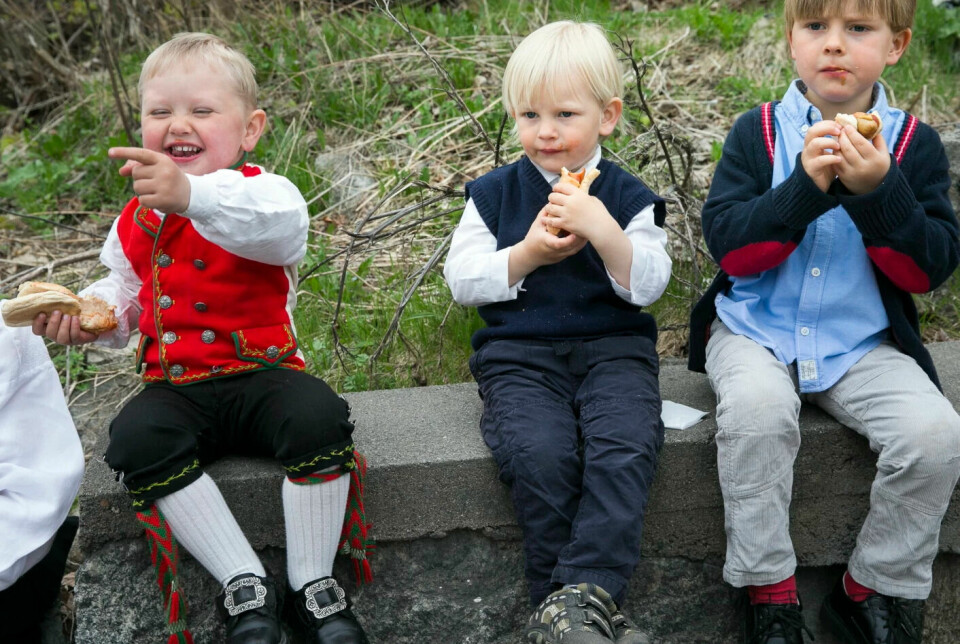 Children eating hot dogs on May 17th, Norway's Constitution Day.