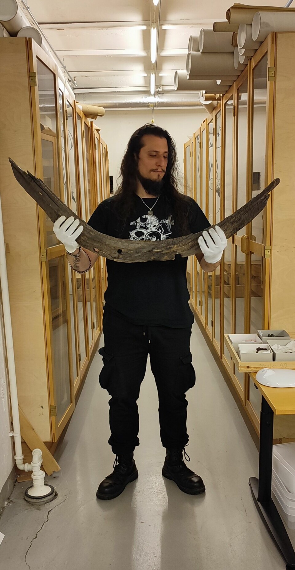 Massimiliano Ditta holds up a part of the Storhaug ship which was found in 1974.