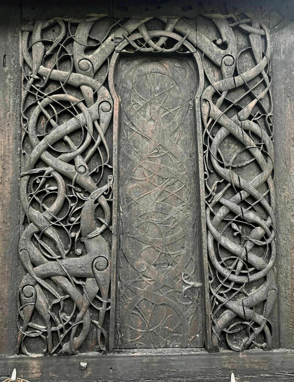 The north portal of the Urnes stave church features the classic Urnes motif with the Urnes beast.