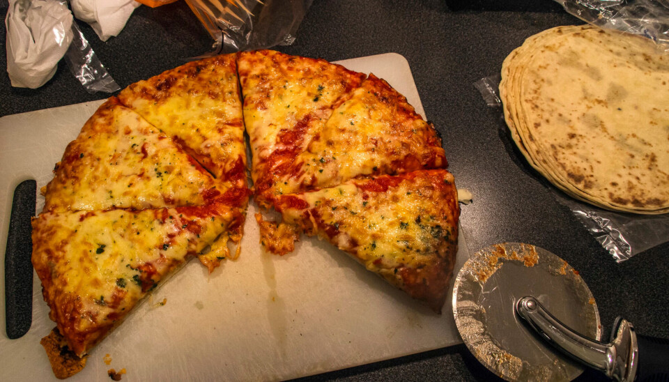 A cooked frozen pizza has been cut into slices. Two slices are missing.