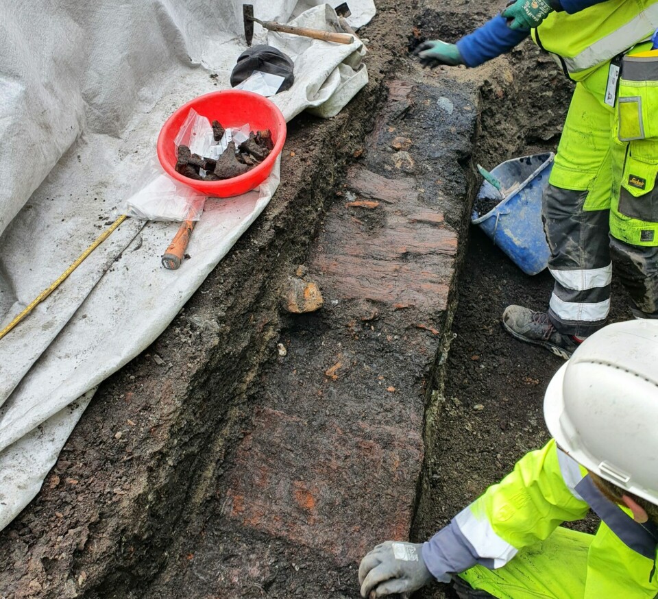 Remains of wooden planks that perhaps once belonged to a medieval street were uncovered above the pit where the gaming piece was located.