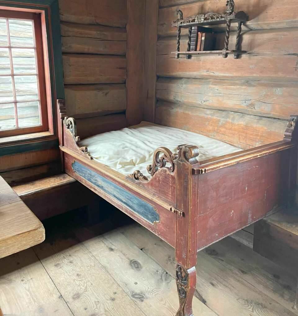 Quite a short bed placed in the corner of a large room. Perhaps a family shared this bed?