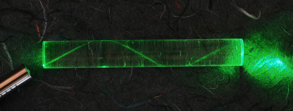 A laser beam is sent through a glass cylinder.